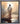 Gabriel Heaton painting of Jesus Christ seen from behind walking into brilliant white light reflected in calm water surrounded by dramatic clouds