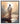 Gabriel Heaton painting of Jesus Christ seen from behind walking into brilliant white light reflected in calm water surrounded by dramatic clouds