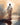 Gabriel Heaton painting of Jesus Christ seen from behind walking into brilliant white light reflected in calm water surrounded by dramatic clouds