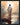 Gabriel Heaton painting of Jesus Christ seen from behind walking into brilliant white light reflected in calm water surrounded by dramatic clouds