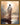 Gabriel Heaton painting of Jesus Christ seen from behind walking into brilliant white light reflected in calm water surrounded by dramatic clouds