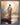 Gabriel Heaton painting of Jesus Christ seen from behind walking into brilliant white light reflected in calm water surrounded by dramatic clouds