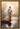 Gabriel Heaton painting of Jesus Christ seen from behind walking into brilliant white light reflected in calm water surrounded by dramatic clouds