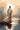 Gabriel Heaton painting of Jesus Christ seen from behind walking into brilliant white light reflected in calm water surrounded by dramatic clouds