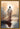 Gabriel Heaton painting of Jesus Christ seen from behind walking into brilliant white light reflected in calm water surrounded by dramatic clouds