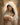 Gabriel Heaton painting of the Virgin Mary in white robes with a soft halo tenderly holding the newborn baby Jesus swaddled in white cloth
