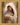 Gabriel Heaton painting of the Virgin Mary in white robes with a soft halo tenderly holding the newborn baby Jesus swaddled in white cloth