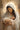 Gabriel Heaton painting of the Virgin Mary in white robes with a soft halo tenderly holding the newborn baby Jesus swaddled in white cloth