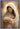 Gabriel Heaton painting of the Virgin Mary in white robes with a soft halo tenderly holding the newborn baby Jesus swaddled in white cloth