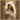 Gabriel Heaton painting of the Virgin Mary in white robes with a soft halo tenderly holding the newborn baby Jesus swaddled in white cloth