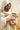 Gabriel Heaton painting of Jesus Christ in white robes tenderly holding a small white lamb close to his chest with a gentle loving expression