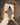 Gabriel Heaton painting of Jesus Christ in white robes standing in the doorway of the empty tomb looking out into bright light beyond the stone archway