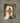 Gabriel Heaton painting of Jesus Christ in white robes standing in the doorway of the empty tomb looking out into bright light beyond the stone archway