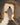 Gabriel Heaton painting of Jesus Christ in white robes standing in the doorway of the empty tomb looking out into bright light beyond the stone archway