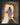 Gabriel Heaton painting of Jesus Christ in white robes standing in the doorway of the empty tomb looking out into bright light beyond the stone archway