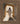 Gabriel Heaton painting of Jesus Christ in white robes standing in the doorway of the empty tomb looking out into bright light beyond the stone archway