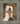 Gabriel Heaton painting of Jesus Christ in white robes standing in the doorway of the empty tomb looking out into bright light beyond the stone archway