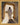 Gabriel Heaton painting of Jesus Christ in white robes standing in the doorway of the empty tomb looking out into bright light beyond the stone archway