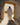 Gabriel Heaton painting of Jesus Christ in white robes standing in the doorway of the empty tomb looking out into bright light beyond the stone archway