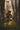 Gabriel Heaton painting of Moroni kneeling in prayer in a forest with his sword planted in the ground and rays of light filtering through the trees