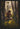 Gabriel Heaton painting of Moroni kneeling in prayer in a forest with his sword planted in the ground and rays of light filtering through the trees