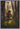 Gabriel Heaton painting of Moroni kneeling in prayer in a forest with his sword planted in the ground and rays of light filtering through the trees