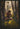 Gabriel Heaton painting of Moroni kneeling in prayer in a forest with his sword planted in the ground and rays of light filtering through the trees