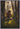 Gabriel Heaton painting of Moroni kneeling in prayer in a forest with his sword planted in the ground and rays of light filtering through the trees