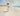 Gabriel Heaton painting of Jesus Christ in white robes carrying a young woman along a sandy beach with ocean waves