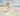 Gabriel Heaton painting of Jesus Christ in white robes carrying a young woman along a sandy beach with ocean waves