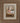 Gabriel Heaton painting of the baby Jesus sleeping in a golden straw manger with a white lamb resting beside him in soft warm light