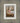 Gabriel Heaton painting of the baby Jesus sleeping in a golden straw manger with a white lamb resting beside him in soft warm light