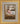 Gabriel Heaton painting of the baby Jesus sleeping in a golden straw manger with a white lamb resting beside him in soft warm light