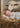 Gabriel Heaton painting of the baby Jesus sleeping in a golden straw manger with a white lamb resting beside him in soft warm light