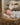 Gabriel Heaton painting of the baby Jesus sleeping in a golden straw manger with a white lamb resting beside him in soft warm light