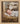 Gabriel Heaton painting of the baby Jesus sleeping in a golden straw manger with a white lamb resting beside him in soft warm light
