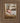 Gabriel Heaton painting of the baby Jesus sleeping in a golden straw manger with a white lamb resting beside him in soft warm light
