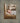 Gabriel Heaton painting of the baby Jesus sleeping in a golden straw manger with a white lamb resting beside him in soft warm light