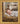 Gabriel Heaton painting of the baby Jesus sleeping in a golden straw manger with a white lamb resting beside him in soft warm light