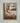 Gabriel Heaton painting of the baby Jesus sleeping in a golden straw manger with a white lamb resting beside him in soft warm light