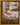 Gabriel Heaton painting of the baby Jesus sleeping in a golden straw manger with a white lamb resting beside him in soft warm light