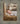 Gabriel Heaton painting of the baby Jesus sleeping in a golden straw manger with a white lamb resting beside him in soft warm light