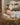 Gabriel Heaton painting of the baby Jesus sleeping in a golden straw manger with a white lamb resting beside him in soft warm light