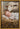 Gabriel Heaton painting of the baby Jesus sleeping in a golden straw manger with a white lamb resting beside him in soft warm light