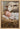 Gabriel Heaton painting of the baby Jesus sleeping in a golden straw manger with a white lamb resting beside him in soft warm light