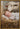 Gabriel Heaton painting of the baby Jesus sleeping in a golden straw manger with a white lamb resting beside him in soft warm light