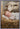 Gabriel Heaton painting of the baby Jesus sleeping in a golden straw manger with a white lamb resting beside him in soft warm light