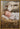 Gabriel Heaton painting of the baby Jesus sleeping in a golden straw manger with a white lamb resting beside him in soft warm light
