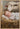 Gabriel Heaton painting of the baby Jesus sleeping in a golden straw manger with a white lamb resting beside him in soft warm light