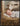 Gabriel Heaton painting of the baby Jesus sleeping in a golden straw manger with a white lamb resting beside him in soft warm light